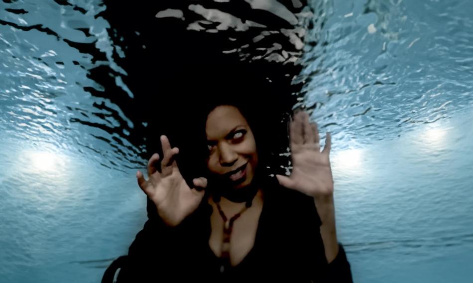 An image of a woman underwater making a scary face
