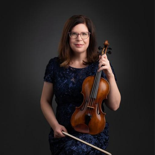 a woman poses holding a violin