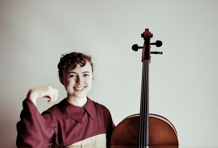 India Gailey smiling with cello