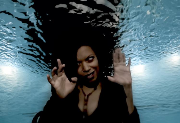 An image of a woman underwater making a scary face